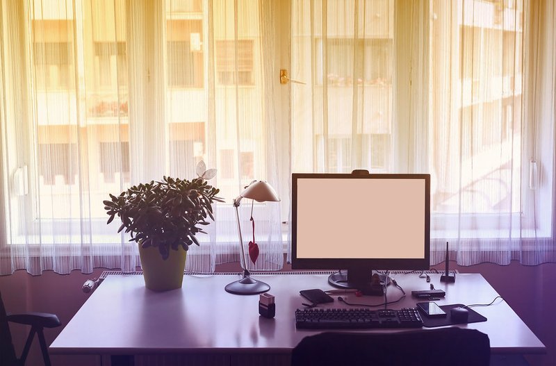 The warm lighting and window view create an inviting, serene workspace that fits the laid-back nomad vibe.